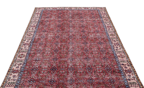 Load image 1 in gallery view. Distressed red Persian-style rug with a repeating floral medallion pattern and a multi-colored border on a white background.