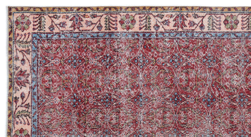 Load image 1 in gallery view. Red and blue traditional rug with a distressed floral medallion pattern and a multi-colored geometric border.