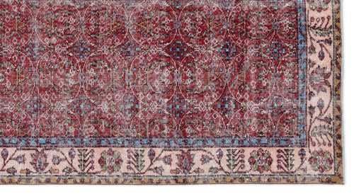 Load image 1 in gallery view. Distressed red traditional rug with a repeating floral medallion pattern and a wide, multi-colored decorative border.