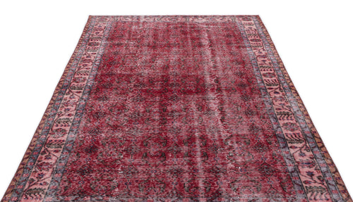 Load image 1 in gallery view. Deep red distressed Persian-style rug with a dark central medallion and intricate floral border on a white background.