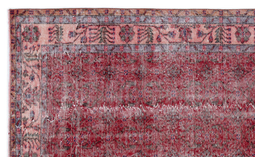 Load image 1 in gallery view. Distressed deep red rug with a faded floral border in pink, blue, and orange on a white background.