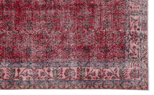 Load image 1 in gallery view. Distressed red and pink traditional rug with a dark floral medallion pattern and a detailed geometric border.