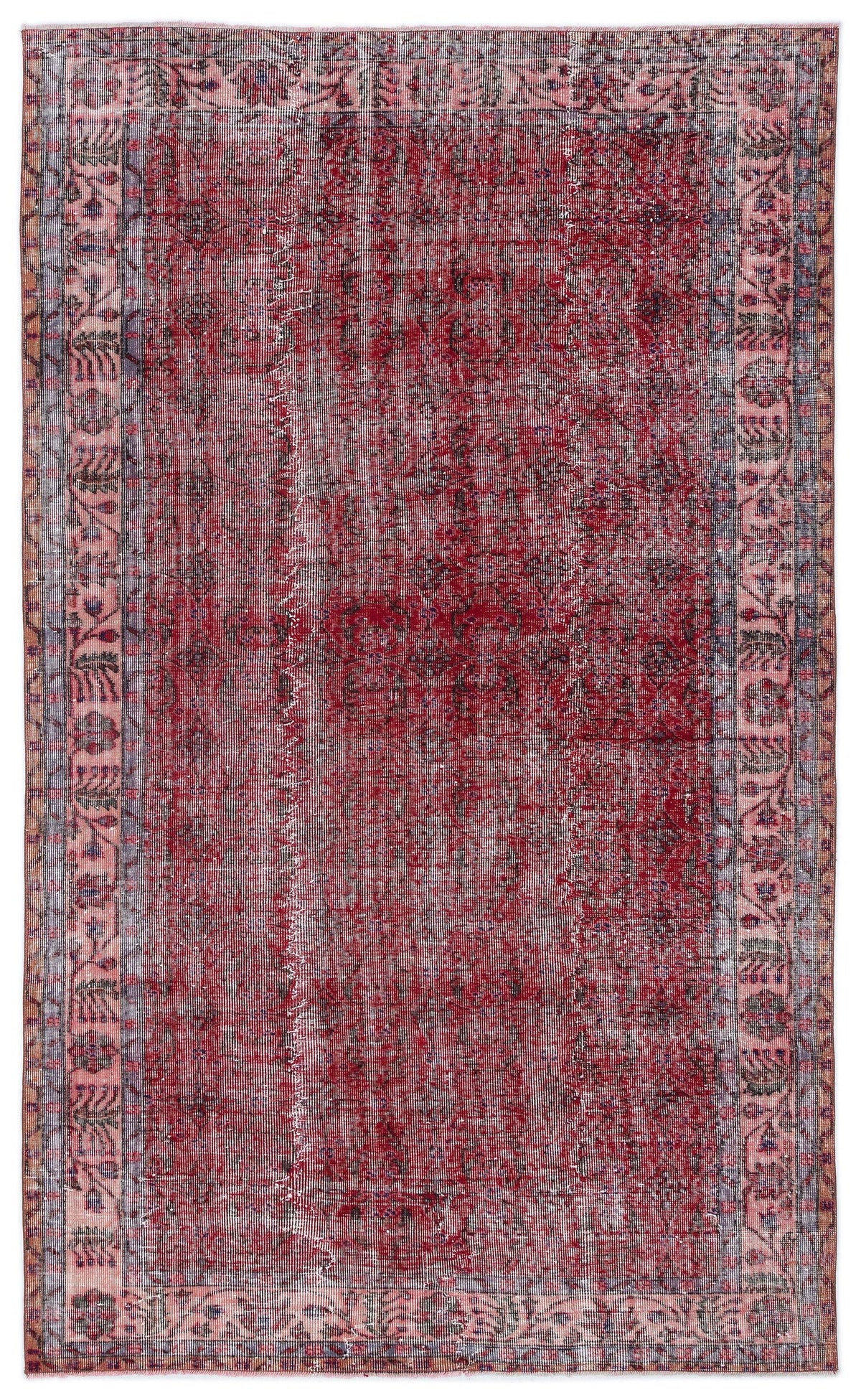 Distressed red and blue vintage-style rug with a central medallion and ornate floral border on a white background.