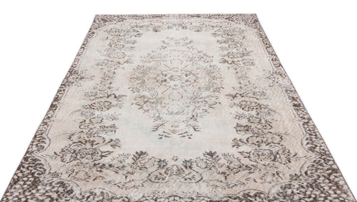Load image 1 in gallery view. Distressed beige and brown rug with a central floral medallion and ornate border pattern on a white background.
