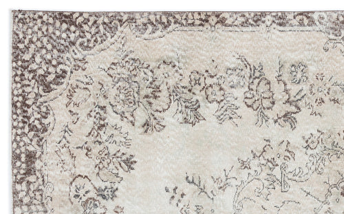Load image 1 in gallery view. Beige and brown distressed rug with a faded floral medallion pattern on a white background.