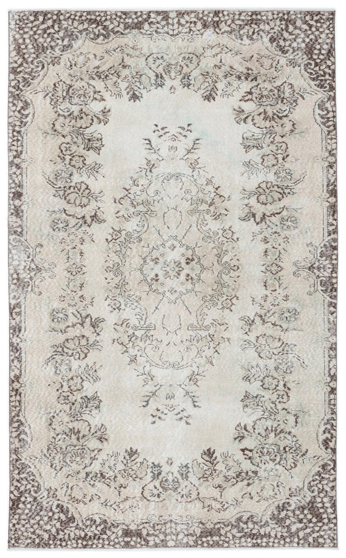 Load image 1 in gallery view. Beige and brown distressed rug with a traditional floral medallion pattern and ornate border.