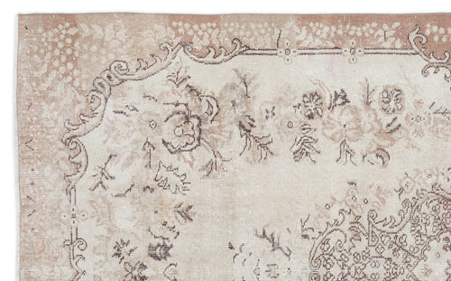 Load image 1 in gallery view. Beige and taupe vintage-style rug with a distressed floral medallion pattern and ornate border.
