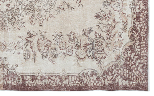 Load image 1 in gallery view. Beige and brown vintage-style rug with a distressed floral medallion pattern and a wide decorative border.