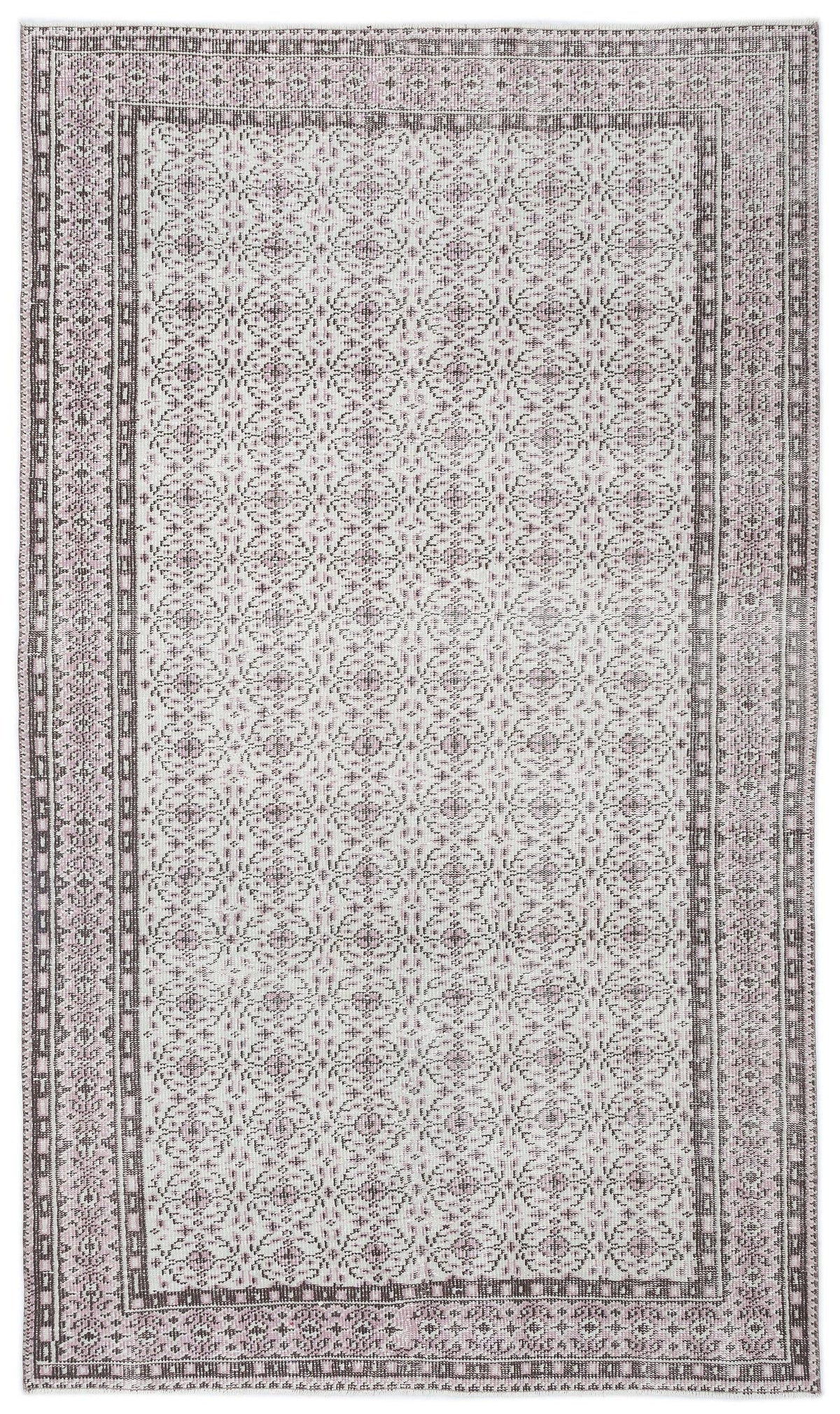 Light pink and charcoal grey rug with a repeating geometric medallion pattern and a decorative border.
