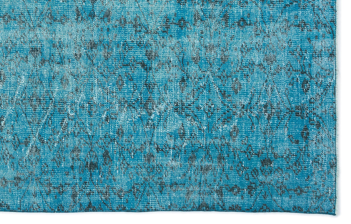 Teal and charcoal distressed rug with a faded traditional medallion pattern.
