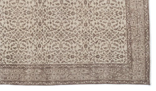 Load image 1 in gallery view. Beige and brown rug with a repeating floral medallion pattern and a wide, detailed border.