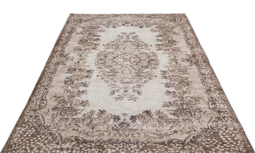 Load image 1 in gallery view. Beige and brown vintage-style rug with a central floral medallion and ornate border on a white background.