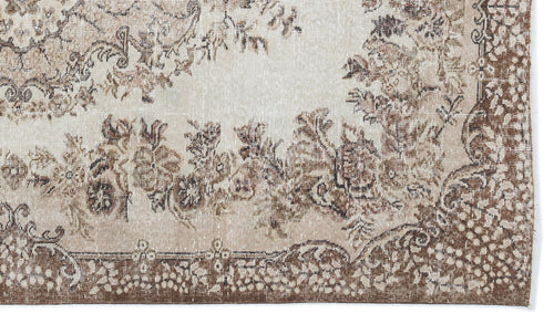 Load image 1 in gallery view. Beige and brown vintage-style rug with a distressed floral medallion pattern and a detailed border.