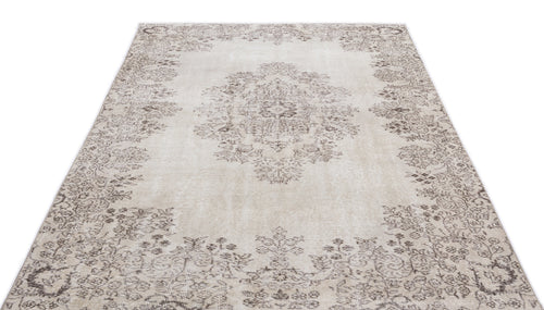 Load image 1 in gallery view. Beige and taupe distressed rug with a central floral medallion and ornate border pattern on a white background.
