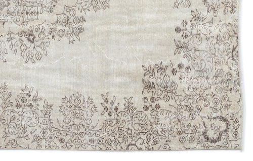 Load image 1 in gallery view. Beige rug with a distressed brown floral pattern and a faded, vintage-style texture.