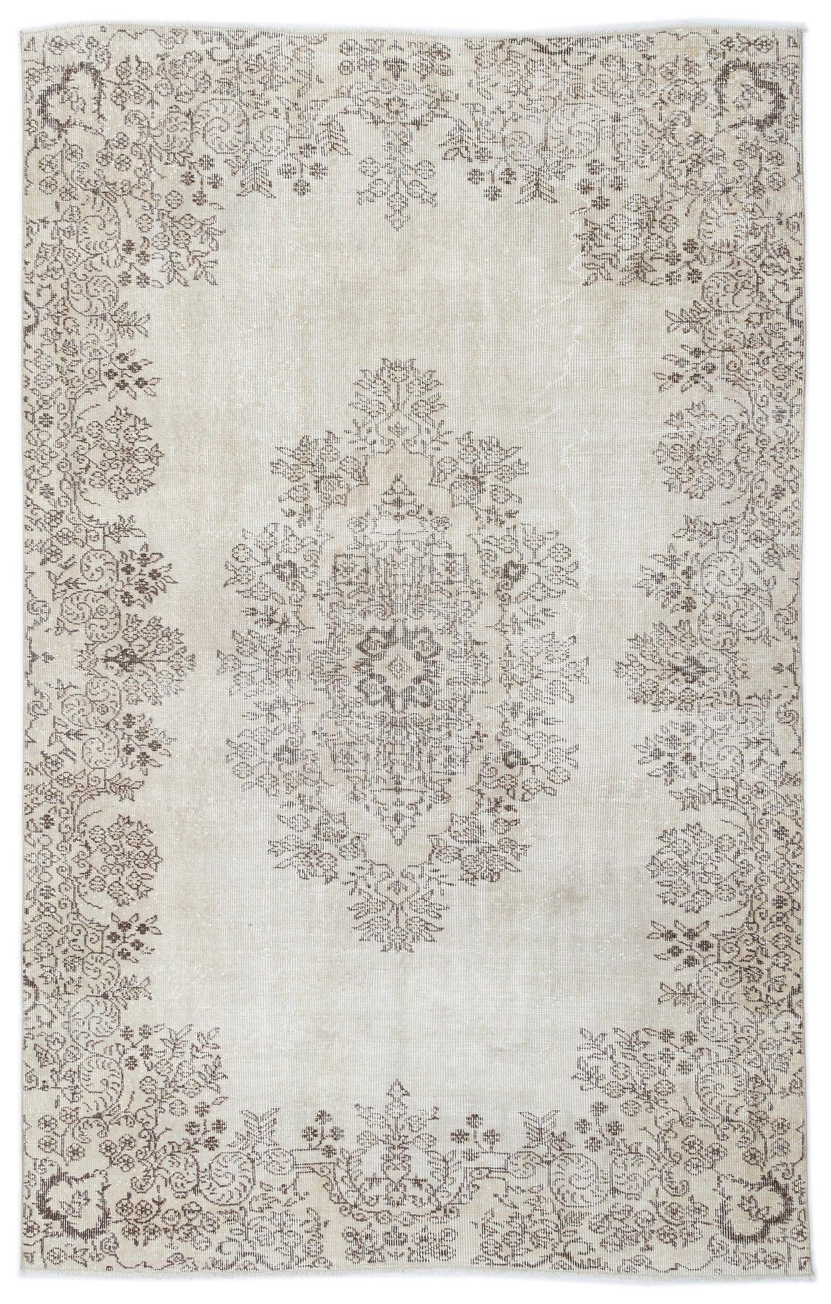 Beige and taupe distressed area rug with a central floral medallion and ornate botanical border.