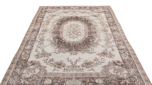 Load image 1 in gallery view. Cream, brown, and muted green vintage-style rug with a central floral medallion and ornate border on a white background.