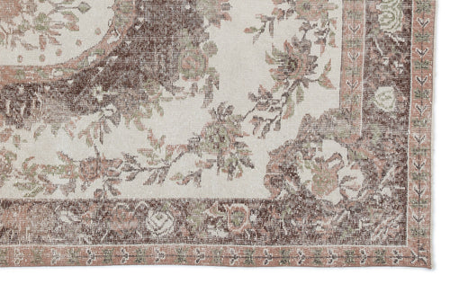 Load image 1 in gallery view. Cream, brown, and muted green vintage-style rug with a distressed floral medallion pattern and a detailed border.
