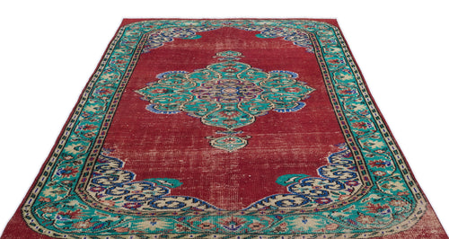 Load image 1 in gallery view. Red vintage-style rug with a central teal and blue floral medallion and a decorative border on a white background.
