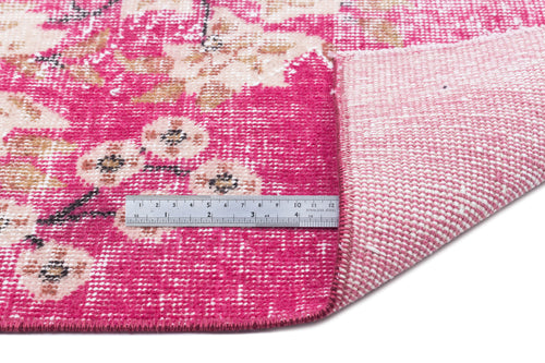 Load image 1 in gallery view. Hot pink and cream floral rug with a distressed texture, shown with a metal ruler for scale on a white background.