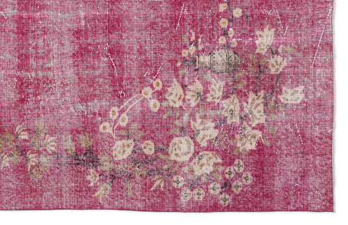 Load image 1 in gallery view. Magenta distressed rug with a faded cream floral pattern and visible woven texture.