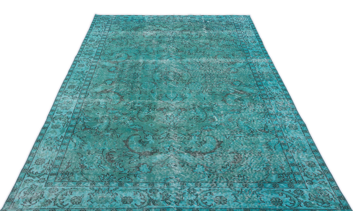 Teal and black distressed traditional rug with an ornate floral medallion pattern on a white background.