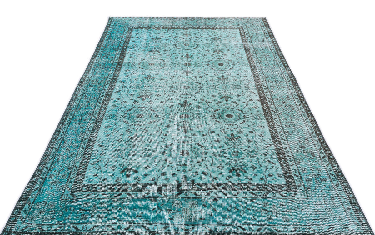 Teal and charcoal distressed area rug with a traditional floral medallion pattern and a wide decorative border.