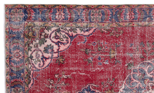 Load image 1 in gallery view. Distressed red traditional rug with a blue border and faded floral medallion pattern.