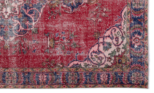 Load image 1 in gallery view. Distressed red, navy, and pink traditional rug with a floral medallion pattern and a detailed geometric border.
