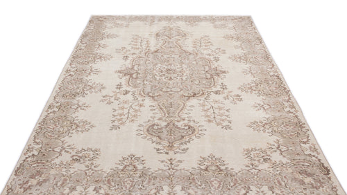 Load image 1 in gallery view. Beige and taupe distressed area rug with a traditional floral medallion pattern on a white background.