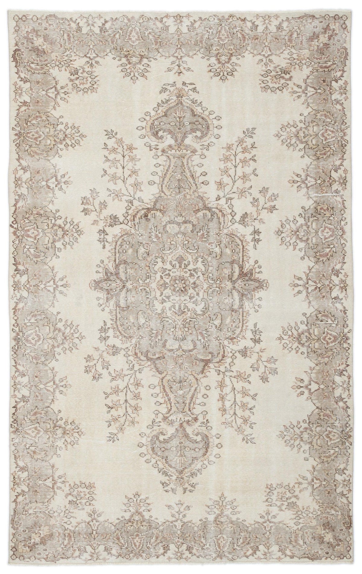 Cream and taupe distressed area rug with a central floral medallion and ornate border pattern.