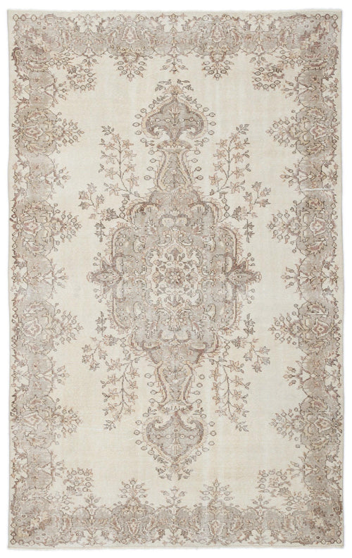 Load image 1 in gallery view. Cream and taupe distressed area rug with a central floral medallion and ornate border pattern.