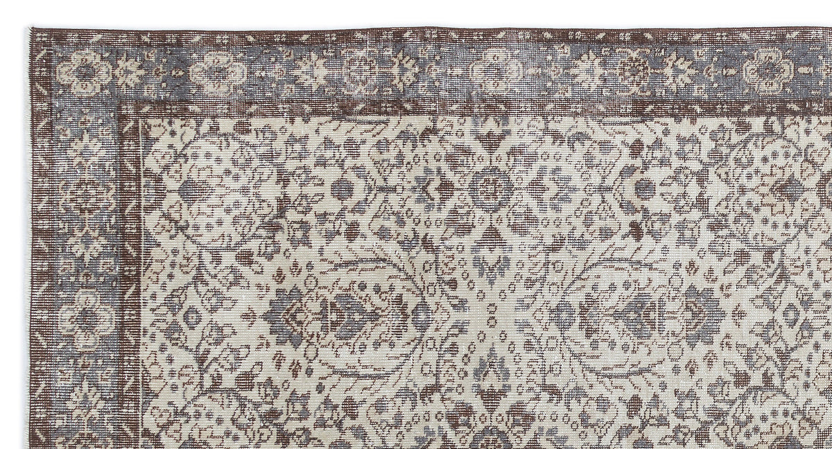 Distressed brown and slate blue traditional rug with an intricate floral medallion pattern and a wide border.