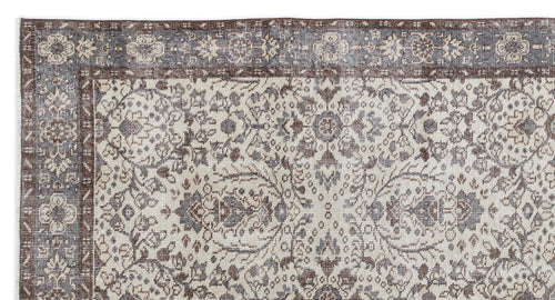 Load image 1 in gallery view. Distressed brown and slate blue traditional rug with an intricate floral medallion pattern and a wide border.