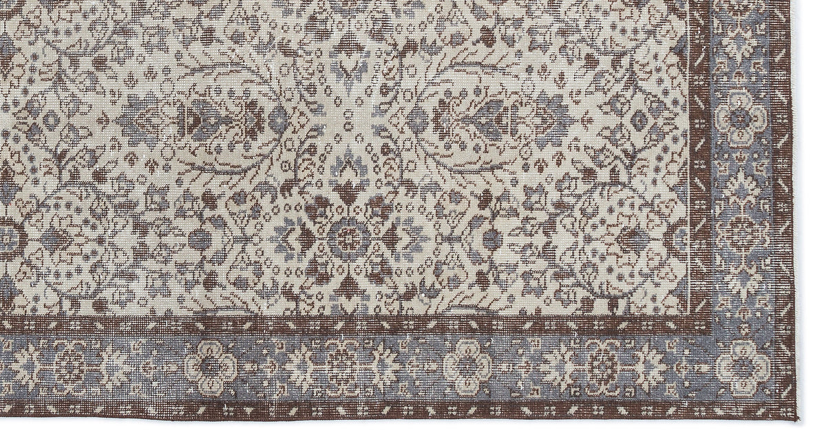 Cream, brown, and slate blue rug with a traditional floral medallion pattern and a detailed geometric border.
