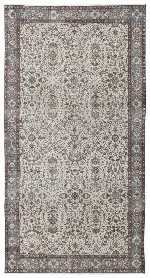 Load image 1 in gallery view. Cream, brown, and slate blue traditional rug with a distressed floral medallion pattern and a wide decorative border.