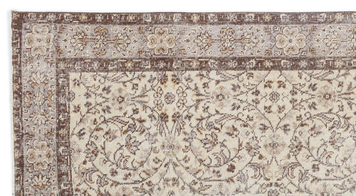 Load image 1 in gallery view. Beige and brown vintage-style rug with a distressed floral medallion pattern and a detailed decorative border.