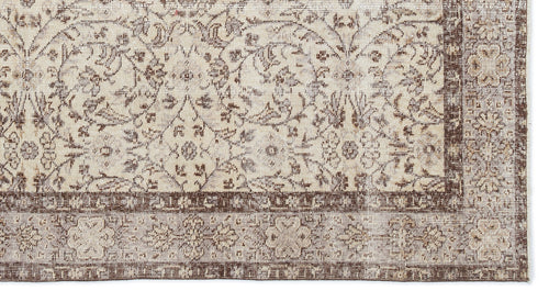 Load image 1 in gallery view. Beige and brown traditional rug with a distressed floral medallion pattern and a detailed border.