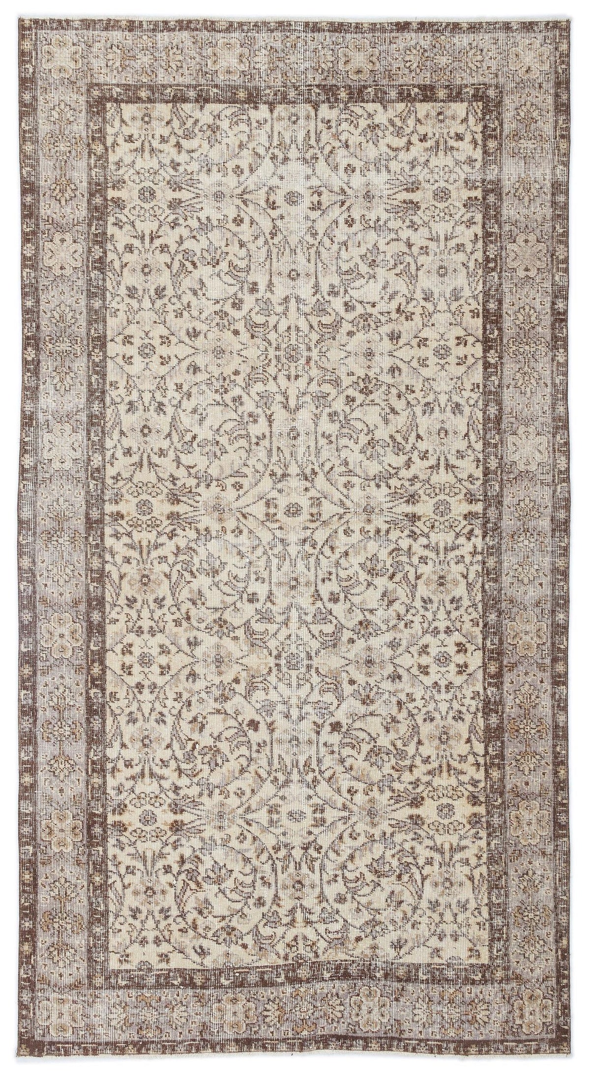 Beige and brown vintage-style rug with a distressed floral medallion pattern and a wide decorative border.