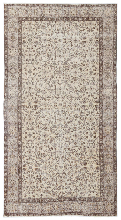 Load image 1 in gallery view. Beige and brown vintage-style rug with a distressed floral medallion pattern and a wide decorative border.