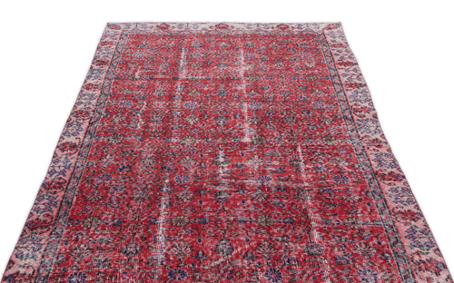 Load image 1 in gallery view. Red vintage-style rug with a distressed floral pattern and faded blue and cream accents on a white background.