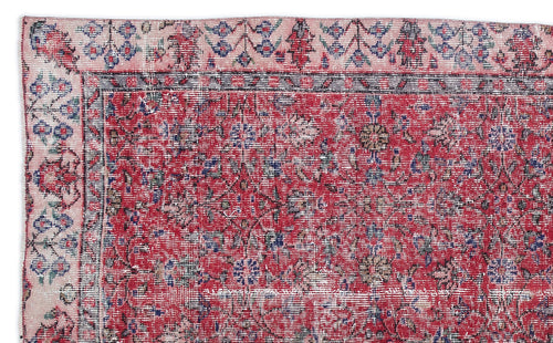 Load image 1 in gallery view. Distressed red rug with a floral medallion pattern, pink border, and blue and white accents on a white background.