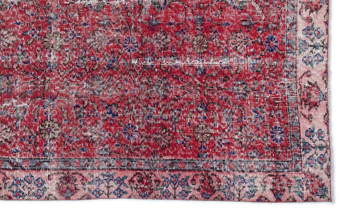 Load image 1 in gallery view. Distressed red rug with a traditional floral pattern, blue and beige accents, and a wide pink border.