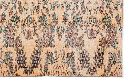 Load image 1 in gallery view. Peach-toned rug with a distressed floral pattern in shades of brown, green, and cream.