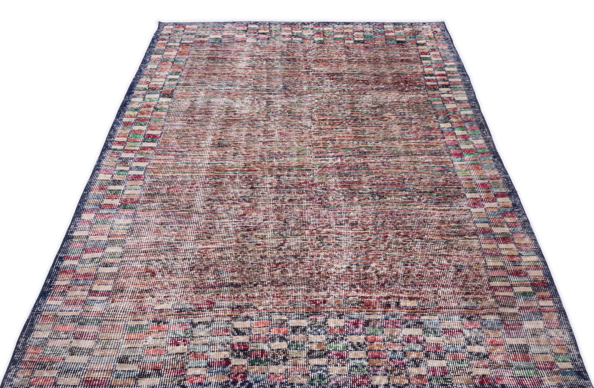 Distressed multi-colored rug with a central textured field and a checkered border on a white background.