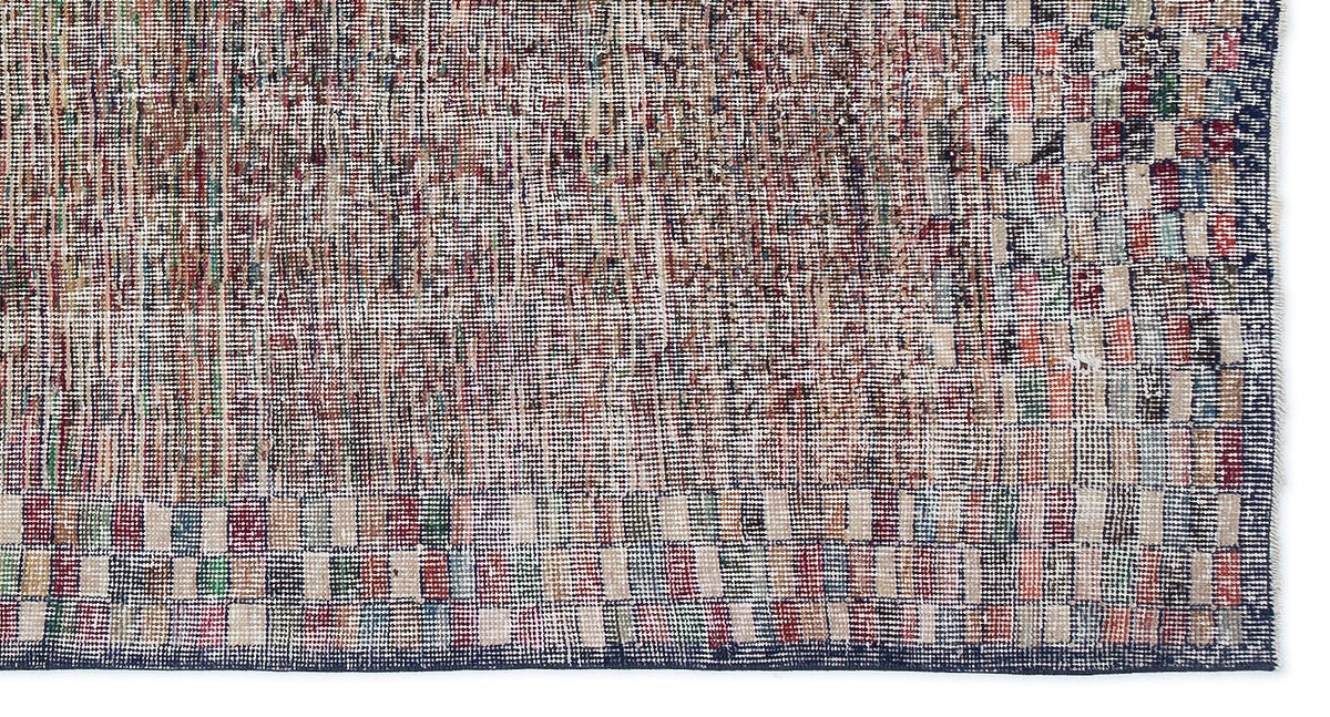Distressed multi-colored rug with a textured, pixelated grid pattern and a dark blue border on a white background.