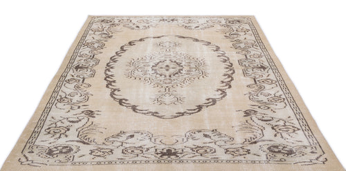 Load image 1 in gallery view. Beige and brown distressed rug with a central medallion and ornate floral border on a white background.