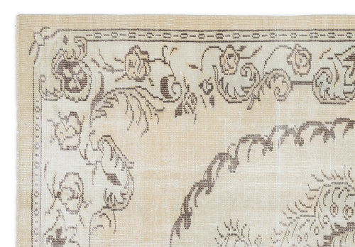 Load image 1 in gallery view. Beige rug with a dark brown floral medallion pattern and a decorative border.