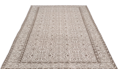 Load image 1 in gallery view. Beige and brown area rug with a distressed, intricate floral medallion pattern and a geometric border.