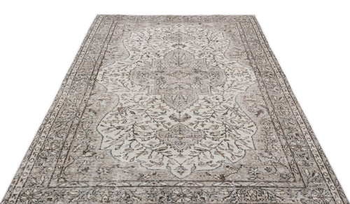Load image 1 in gallery view. Beige and grey distressed area rug with a traditional central floral medallion and ornate border pattern.